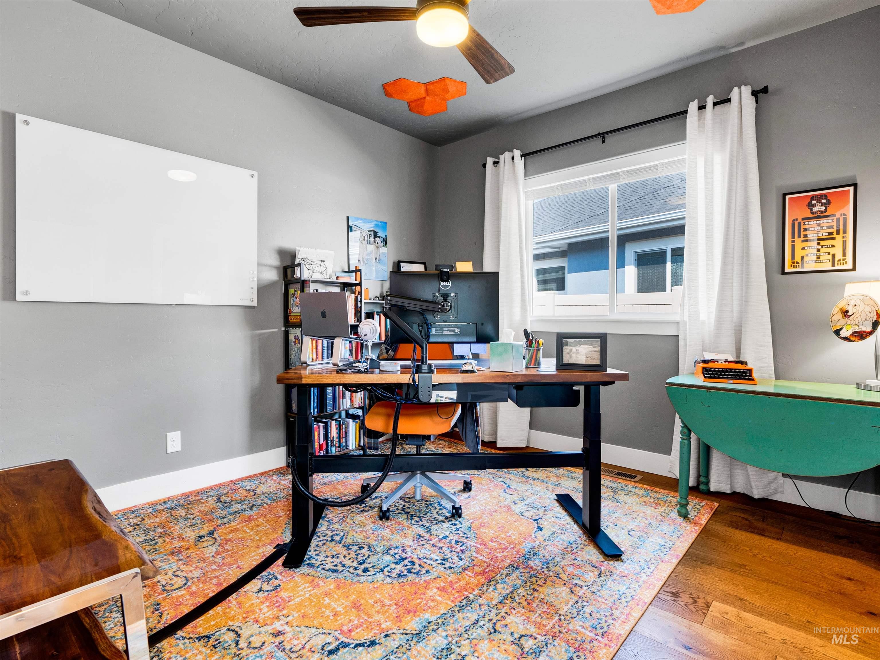 Home office featuring wood finished floors and ceiling fan