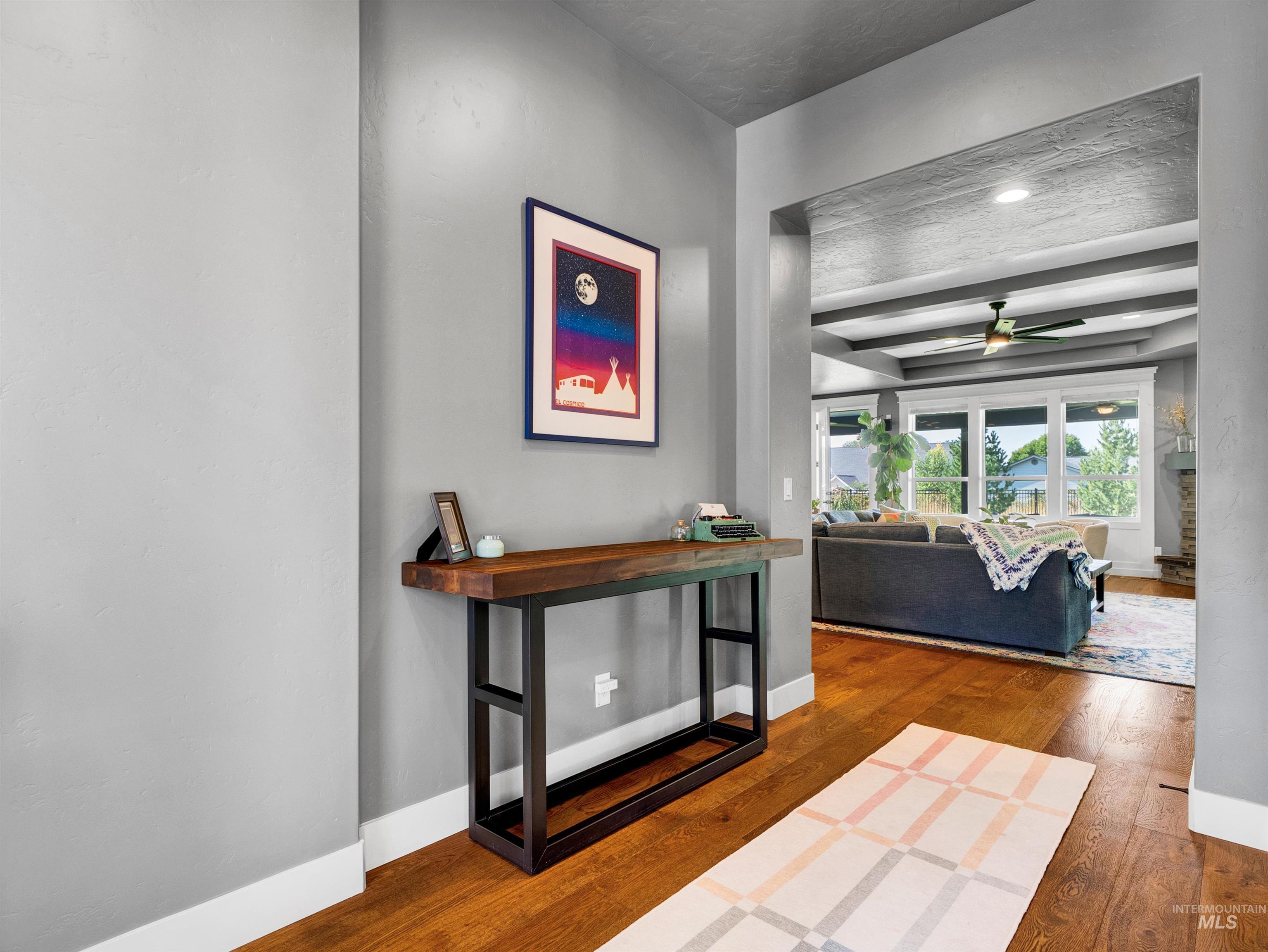Hall with dark wood finished floors and baseboards