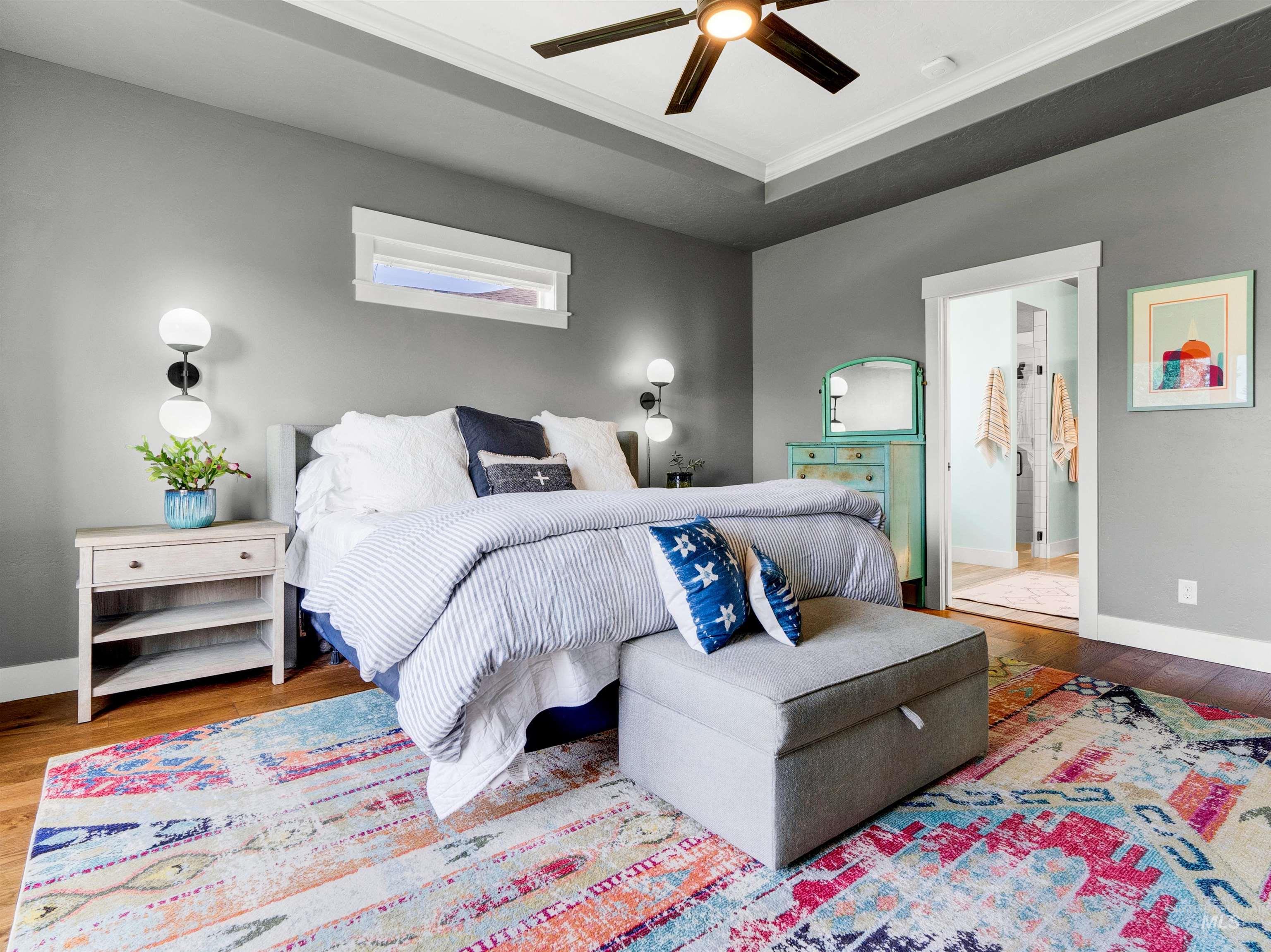 Bedroom featuring wood finished floors, ornamental molding, and ceiling fan