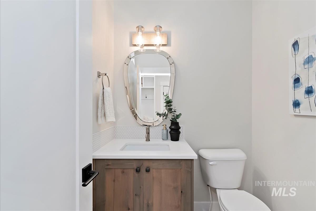 Half bath featuring vanity and toilet