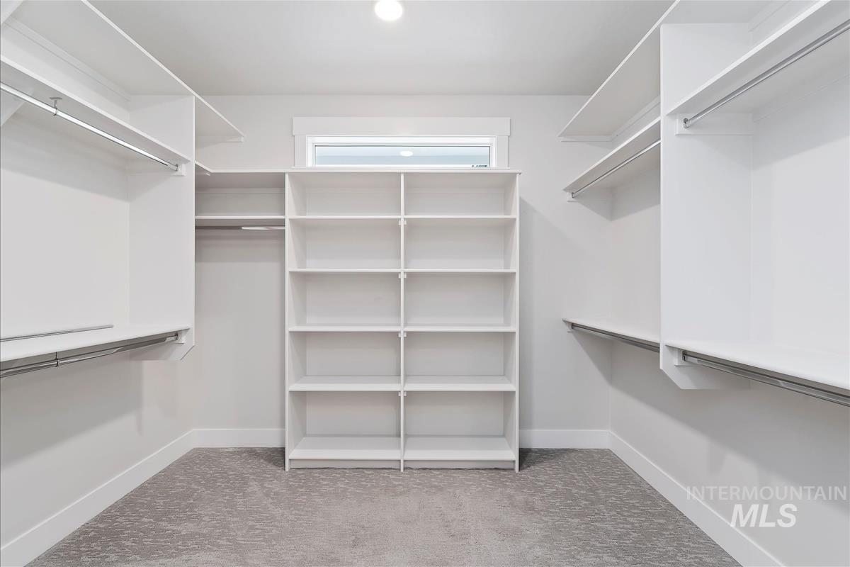 Spacious closet with light colored carpet