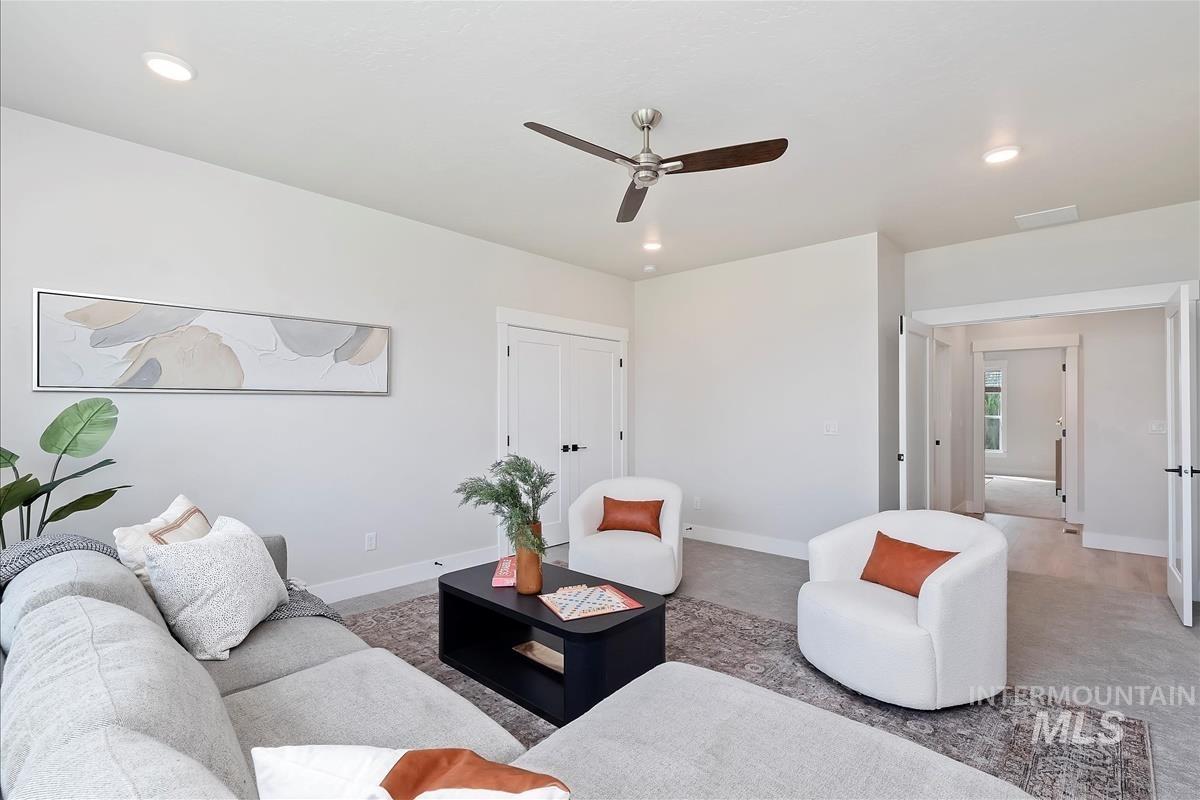 Living room featuring carpet floors, recessed lighting, and a ceiling fan