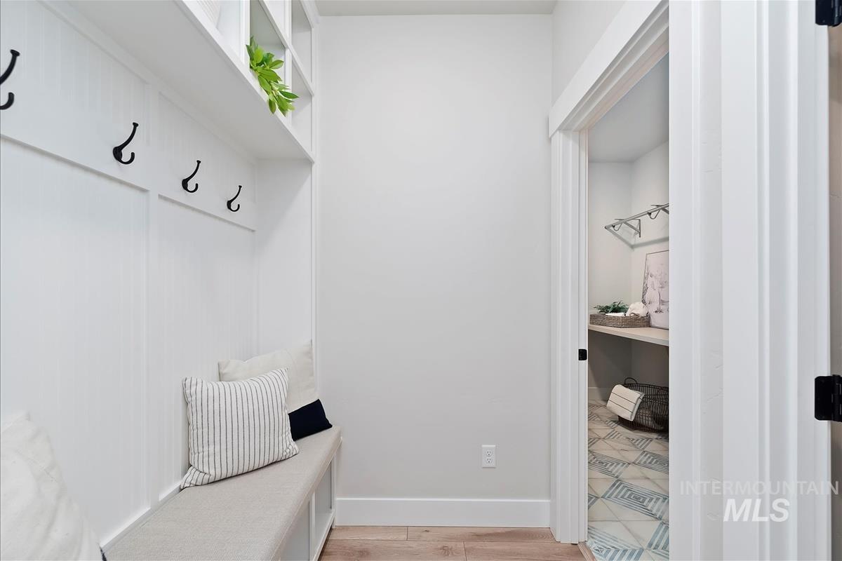 Mudroom with light wood-style floors and baseboards
