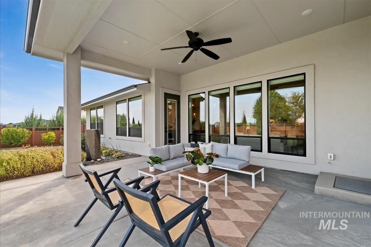 View of patio with an outdoor hangout area and a ceiling fan