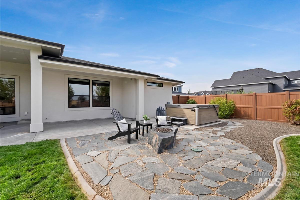 View of patio with a hot tub