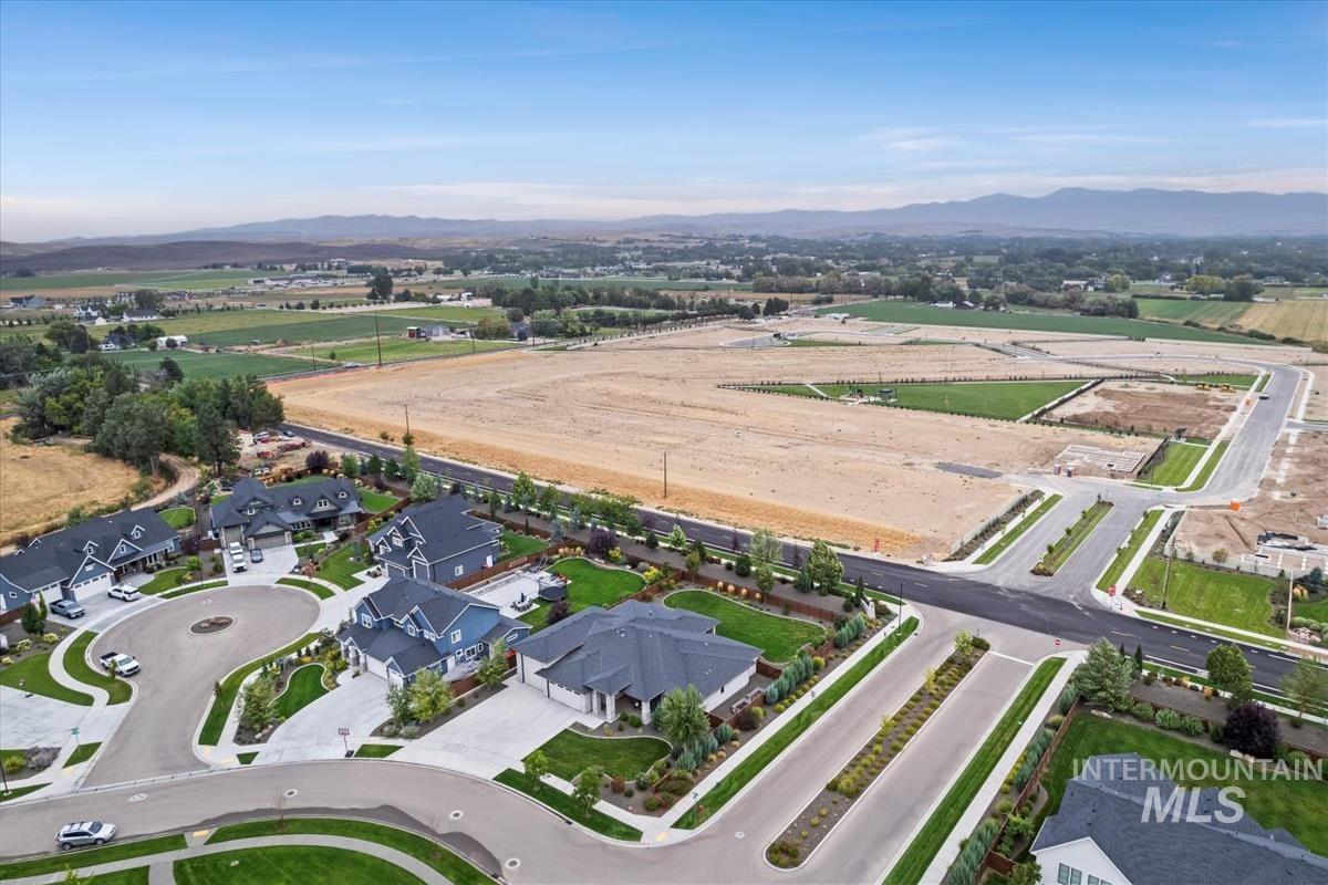 Aerial view of property's location with nearby suburban area and mountains