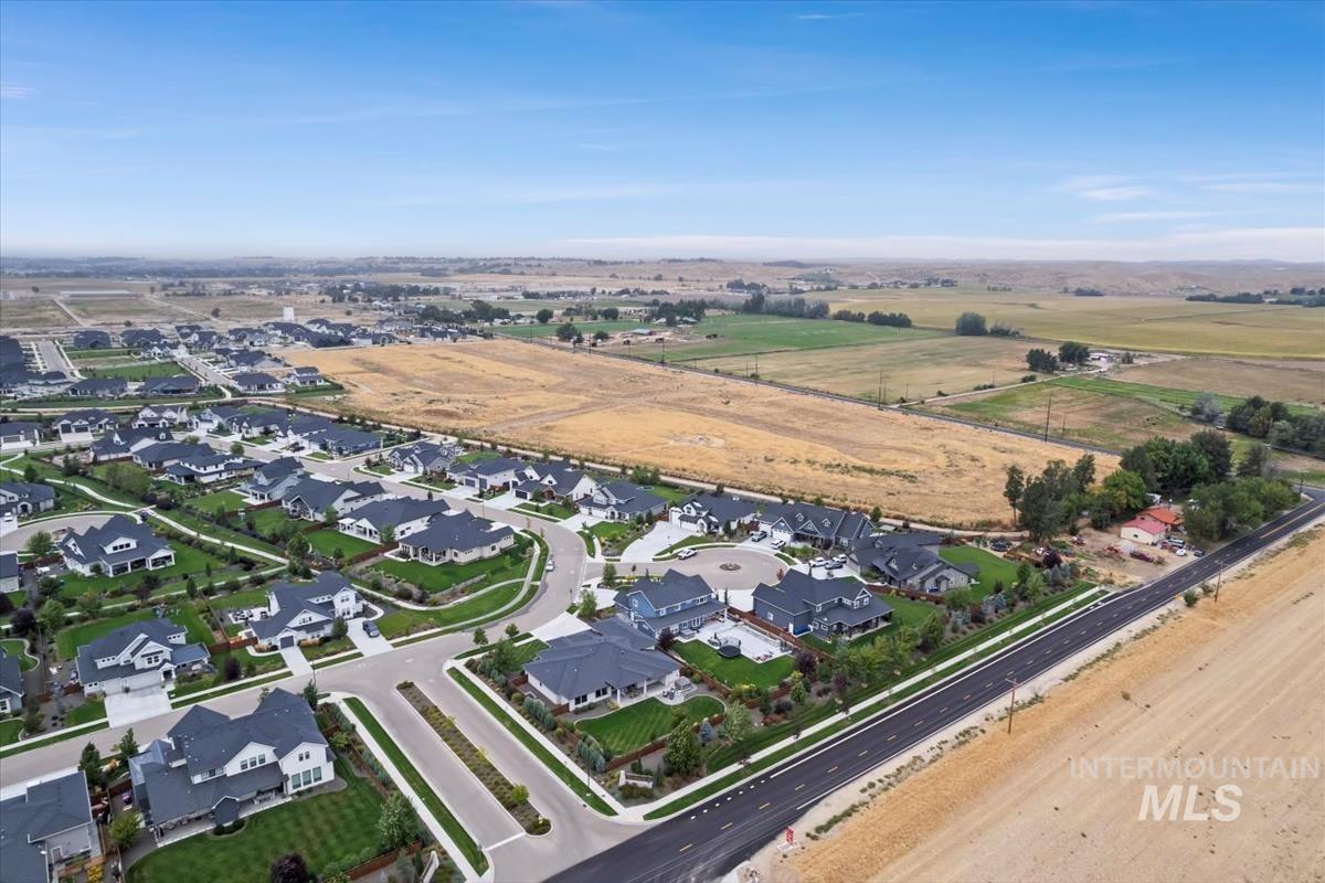 Aerial view of property's location with nearby suburban area