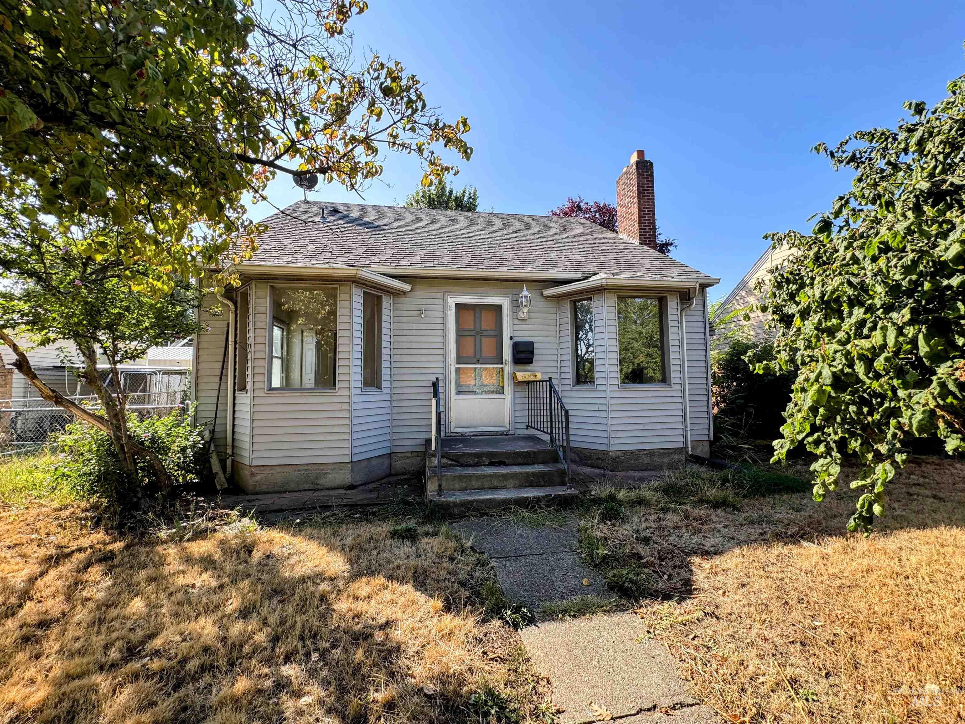 Bungalow-style home with a chimney