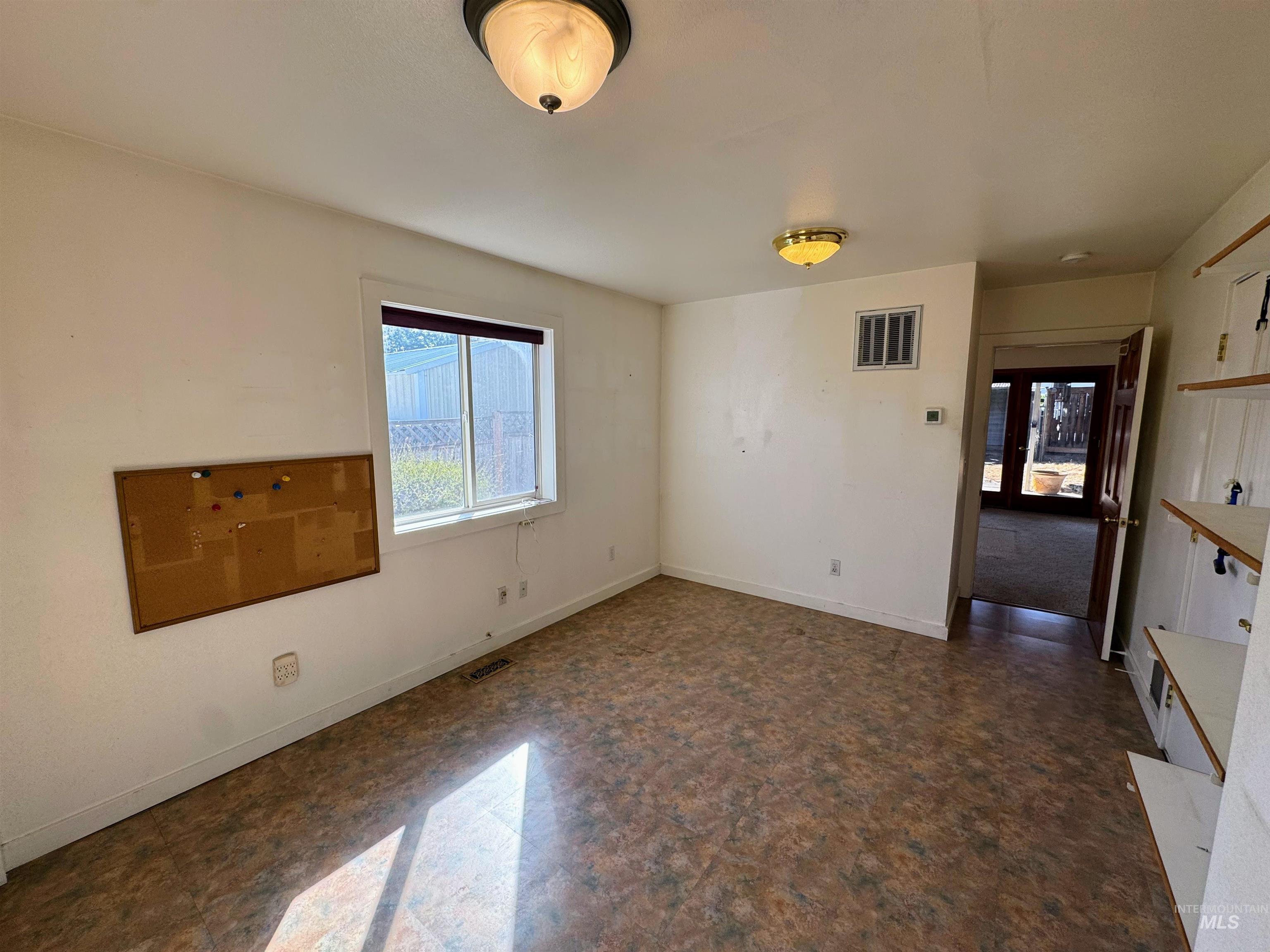 Unfurnished room with baseboards