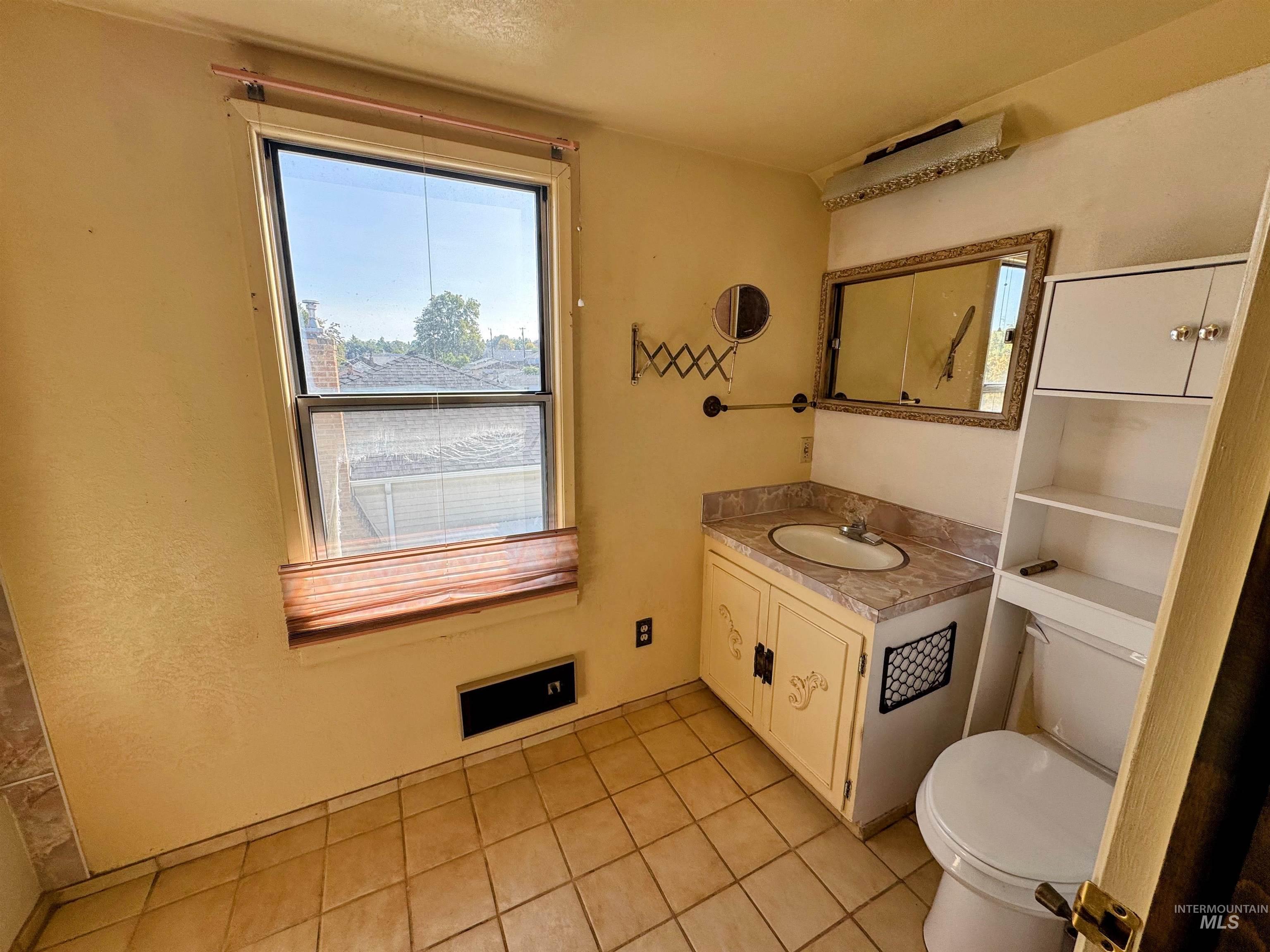 Bathroom with vanity and light tile patterned flooring