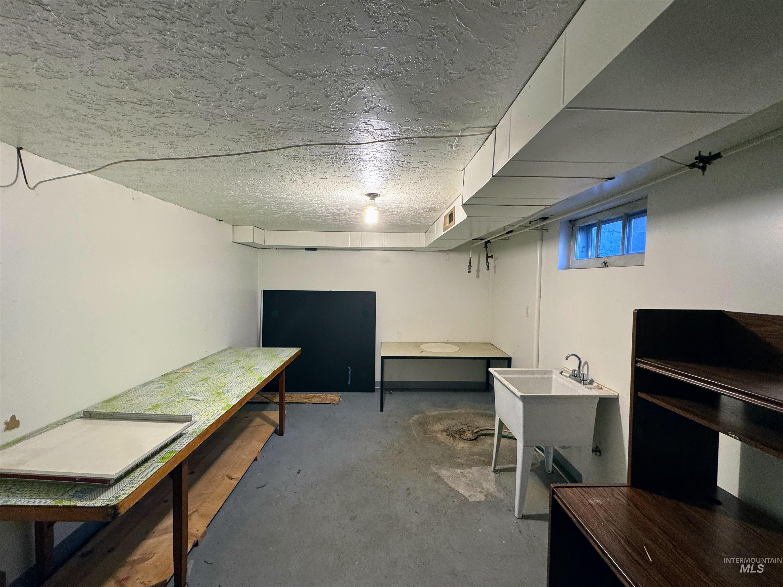 Basement featuring a textured ceiling