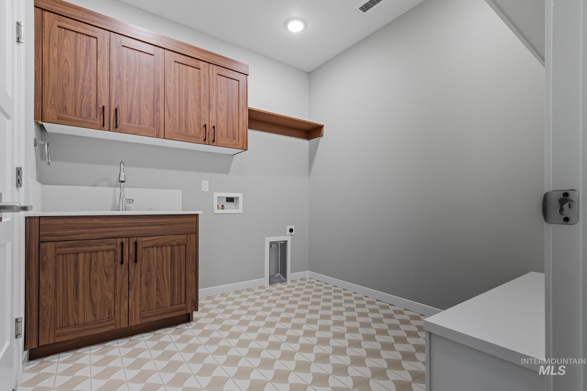 Laundry room featuring washer hookup, light floors, cabinet space, electric dryer hookup, and recessed lighting