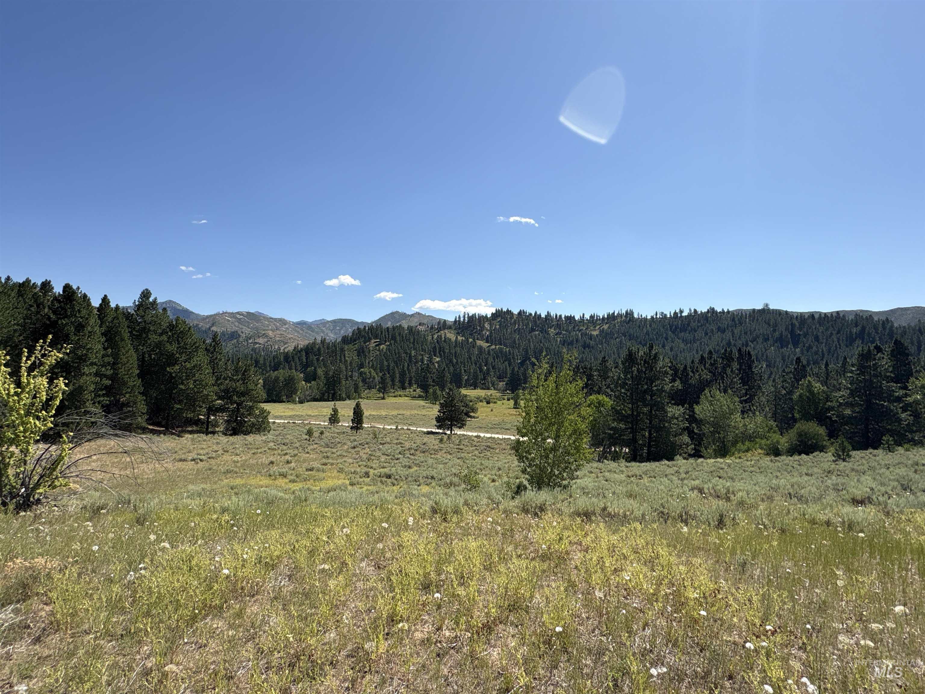 View of mountain backdrop featuring a forest and rural landscape