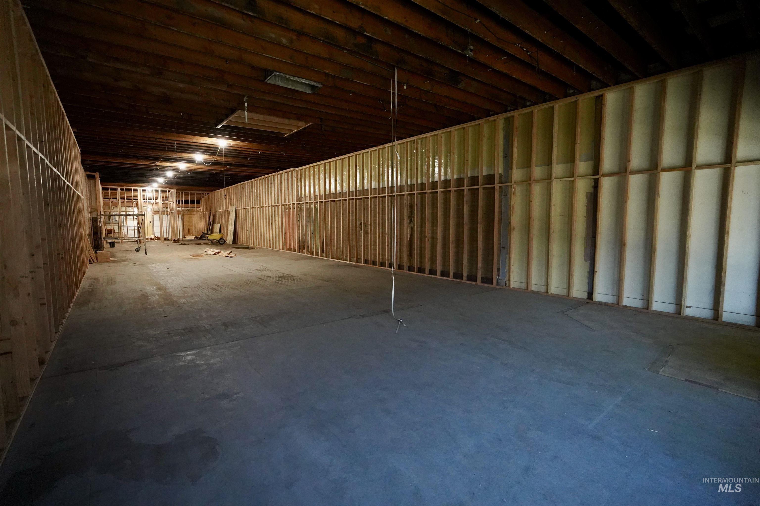 Misc room with unfinished concrete flooring and a garage