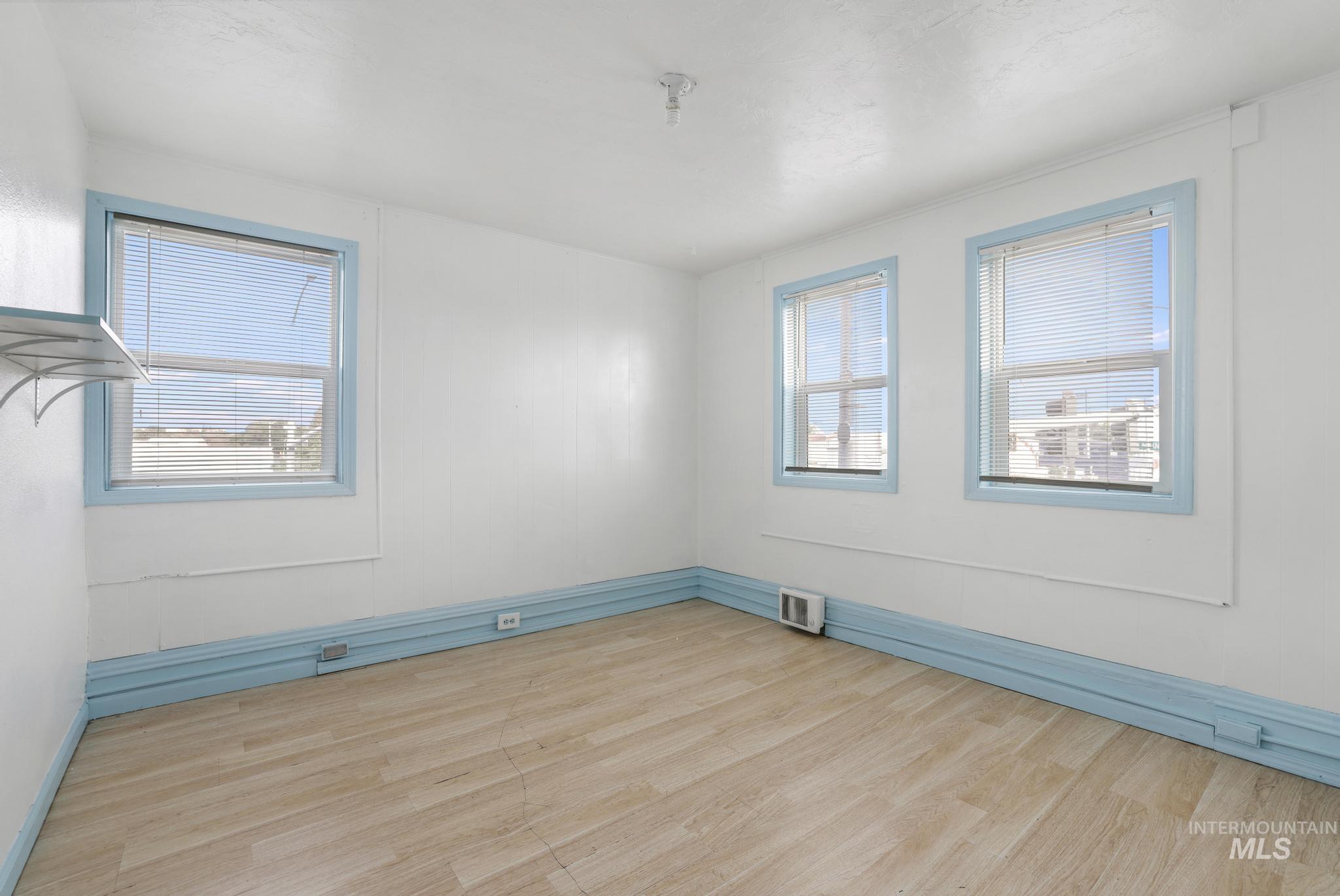 Spare room with light wood finished floors and baseboards