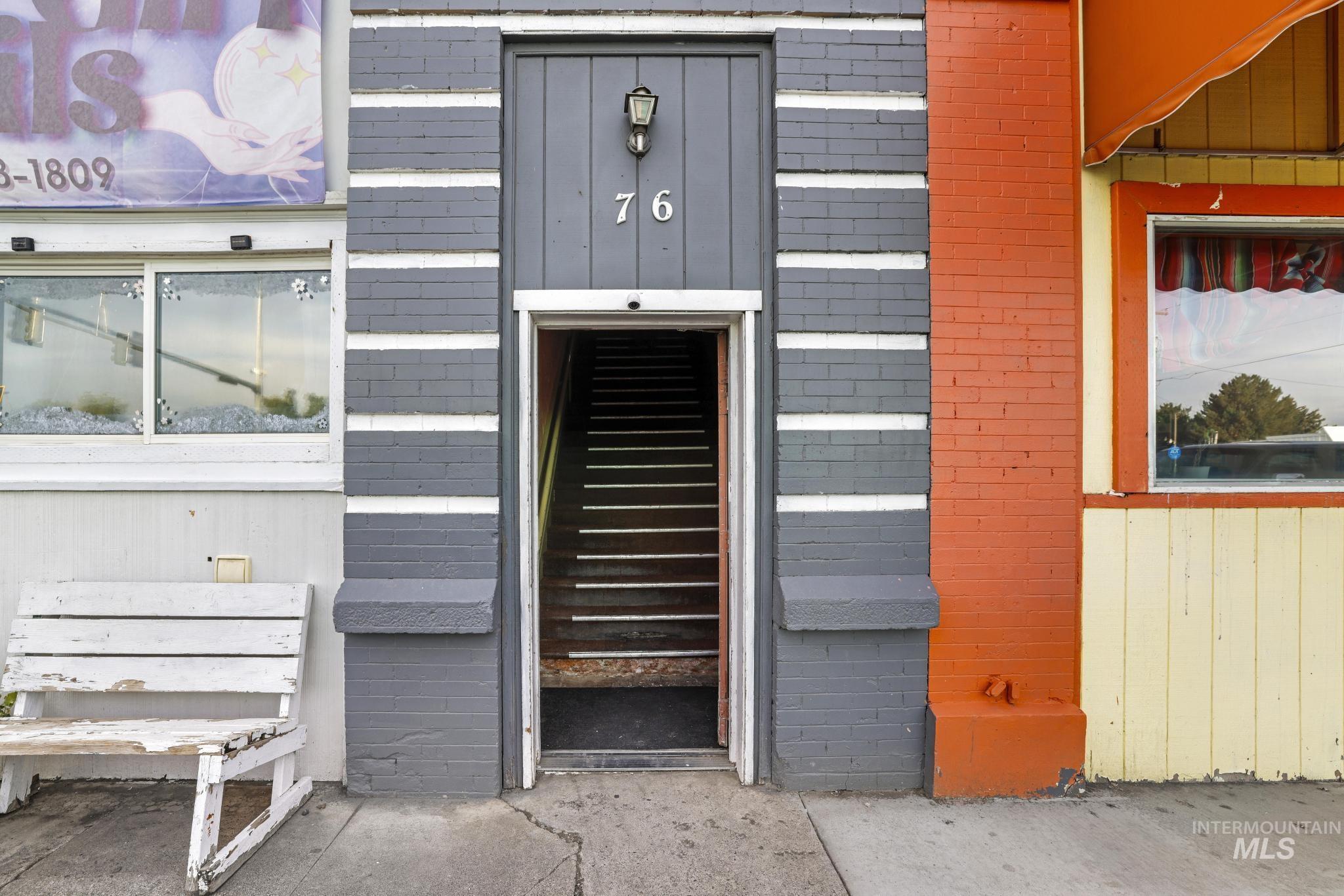 Doorway to property featuring brick siding