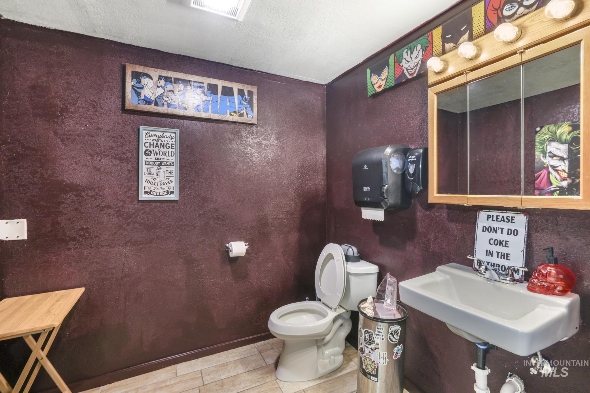 Bathroom featuring toilet and a textured ceiling