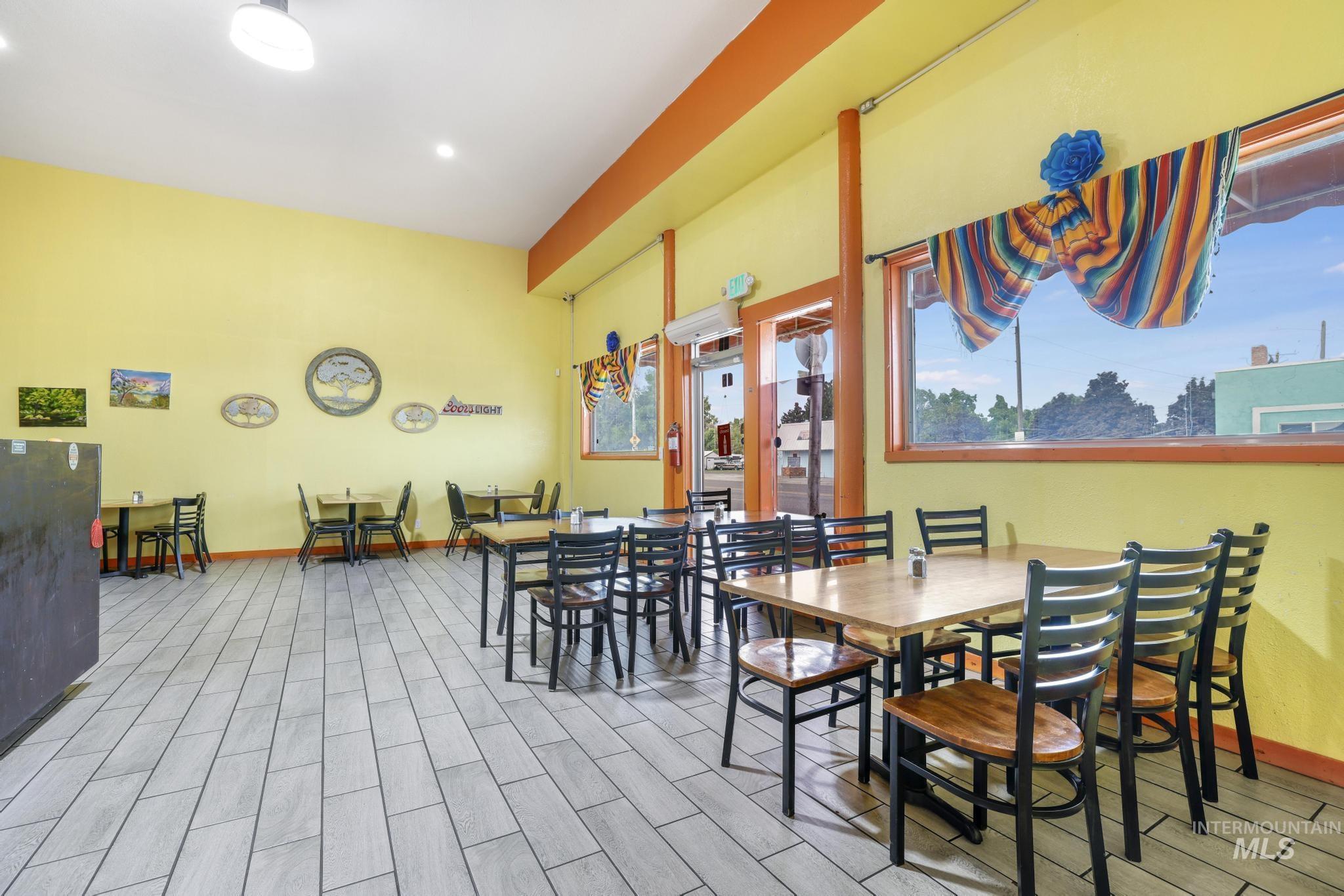 Dining space with wood finish floors and baseboards