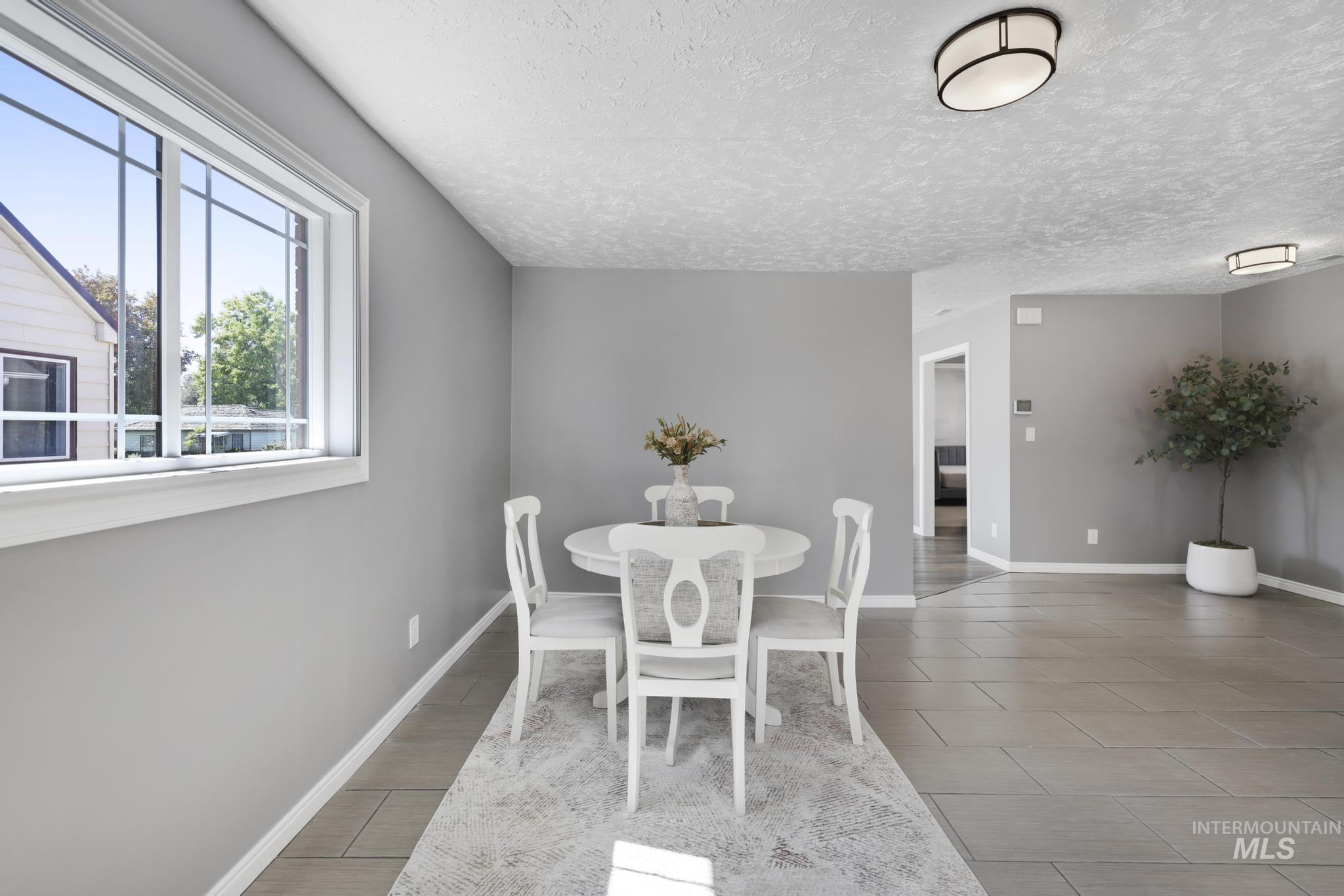 Dining room featuring a textured ceiling and light wood finished floors