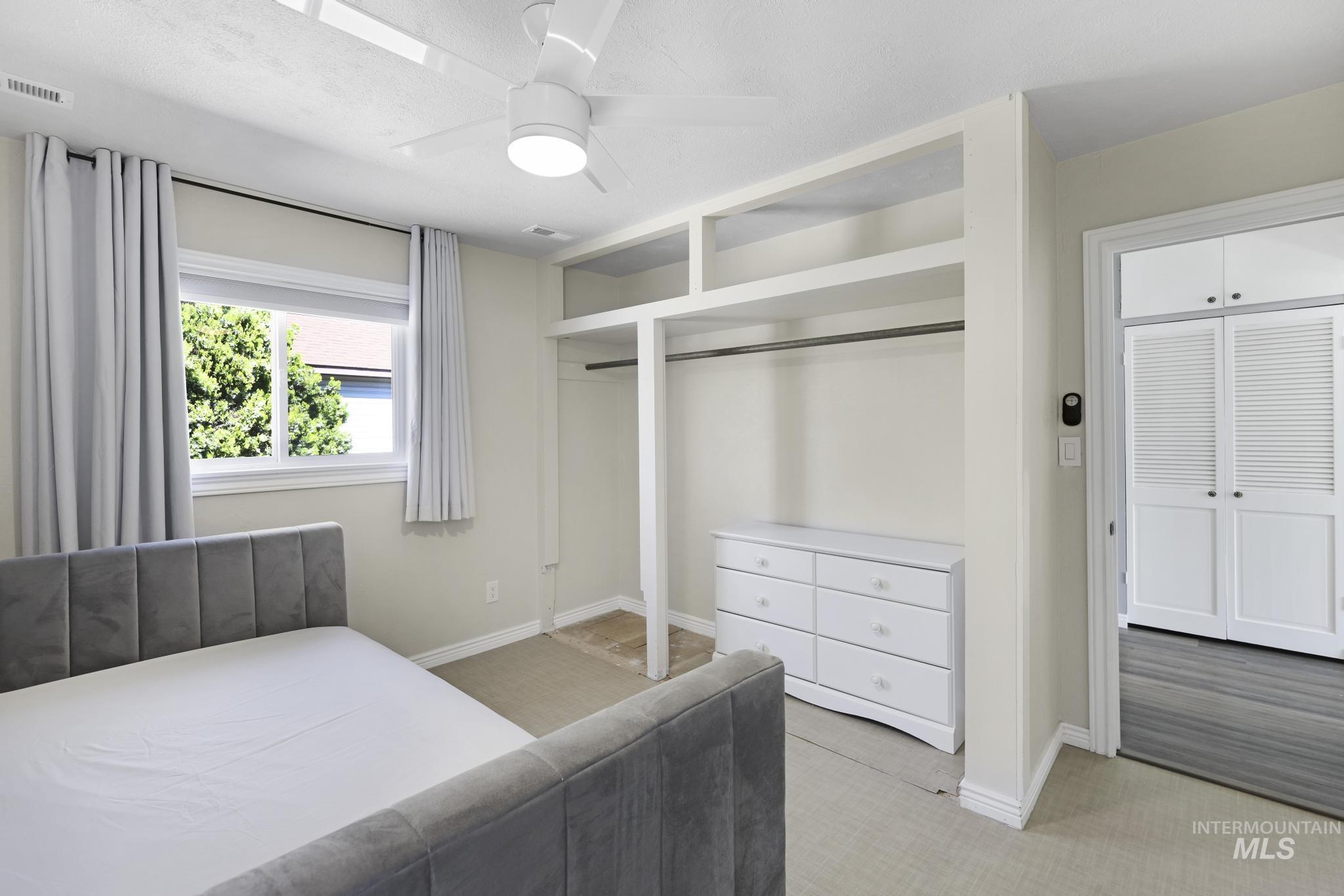 Bedroom featuring light colored carpet and a ceiling fan