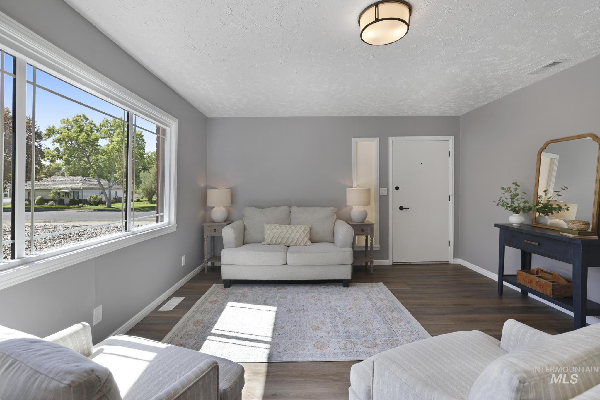 Living room featuring wood finished floors and a textured ceiling