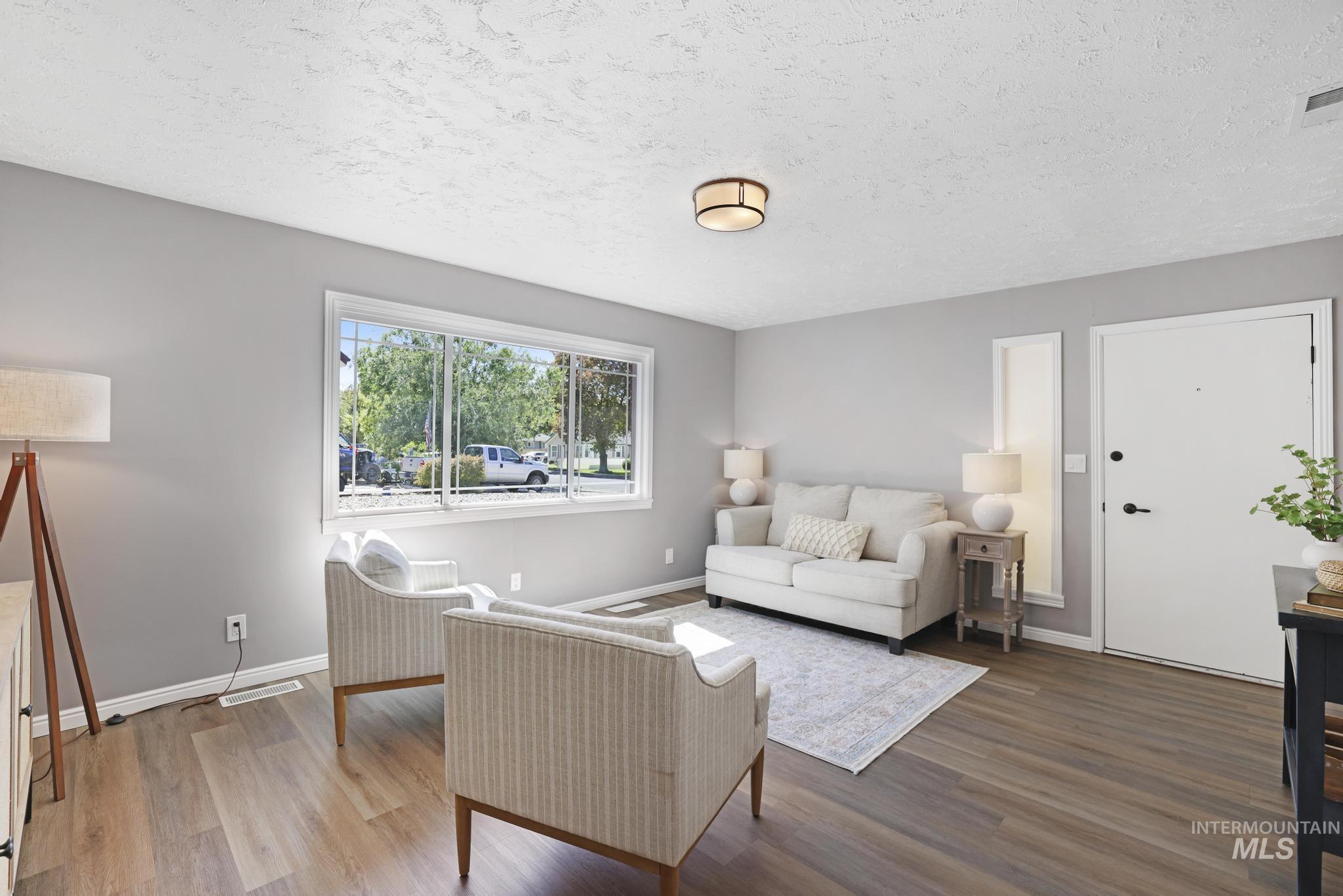 Living room featuring wood finished floors and a textured ceiling