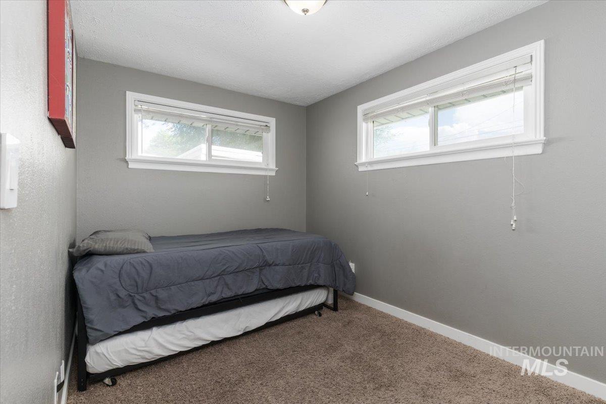 Bedroom with carpet flooring and a textured ceiling