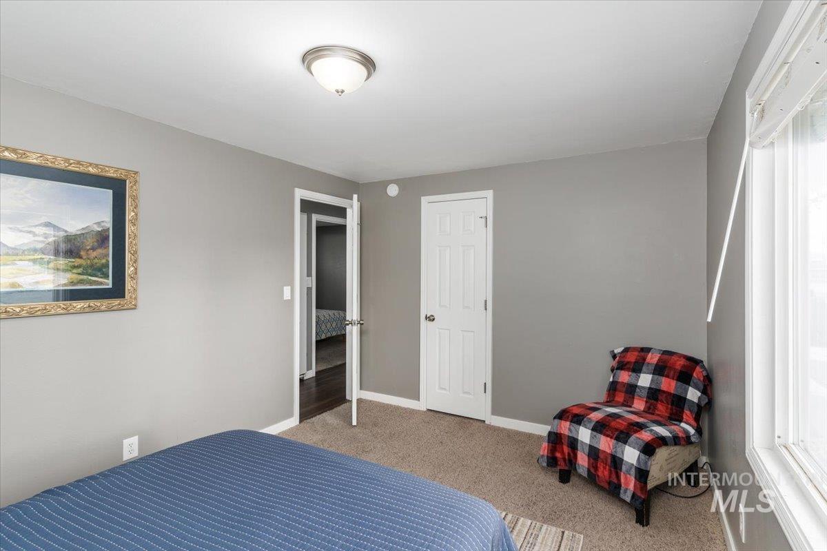 Bedroom featuring carpet floors and baseboards