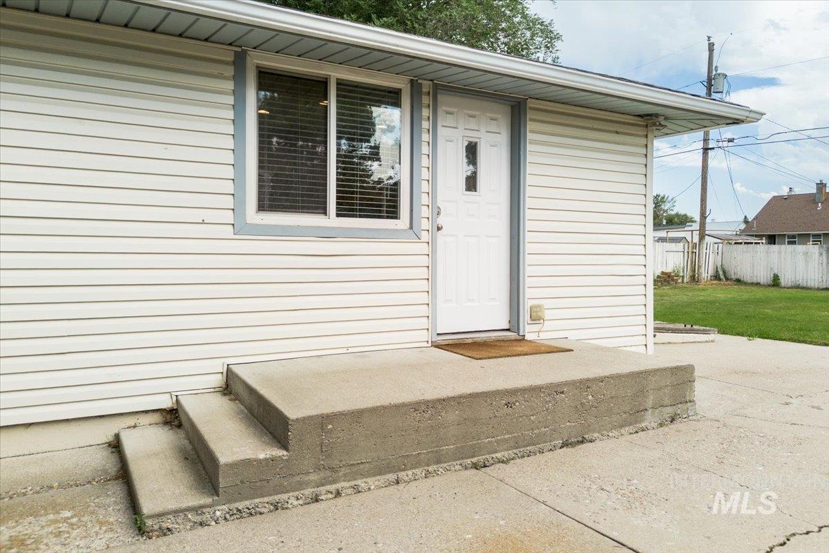 Property entrance with a patio area