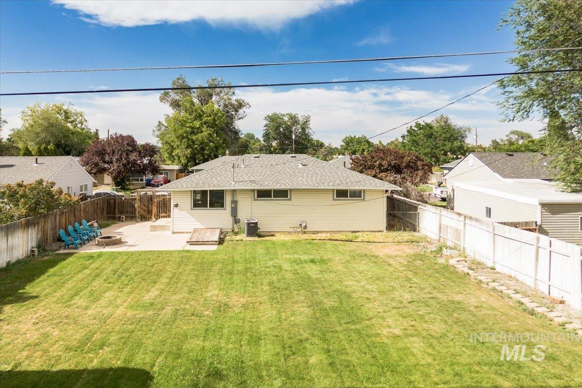 Rear view of house with a patio area and a fenced backyard