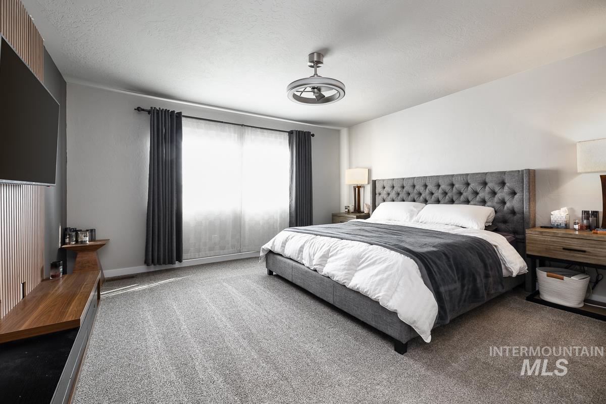 Bedroom featuring carpet floors and a textured ceiling