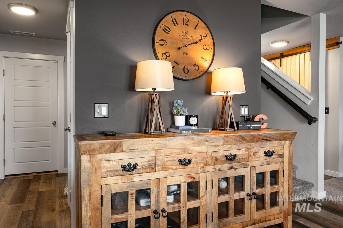 Bar area featuring stairway, wooden counters, and dark wood finished floors