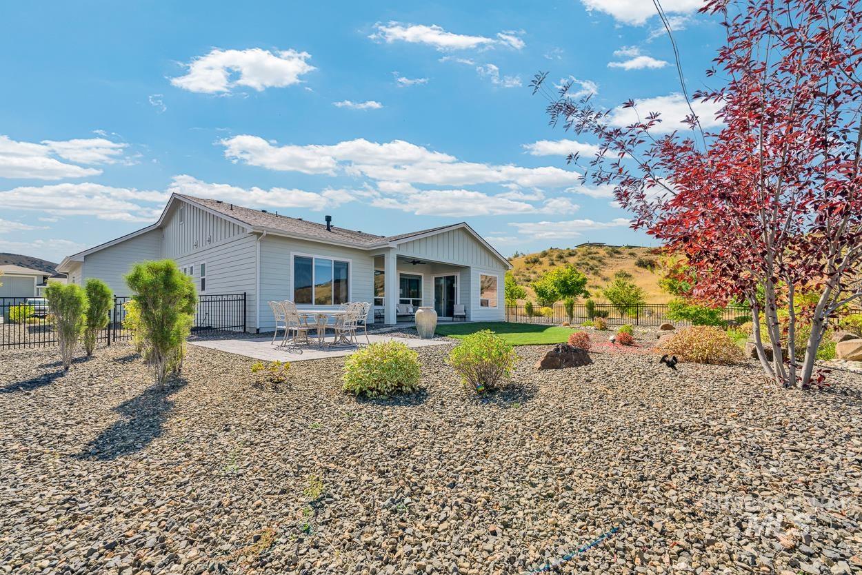 Rear view of house with a patio area and board and batten siding