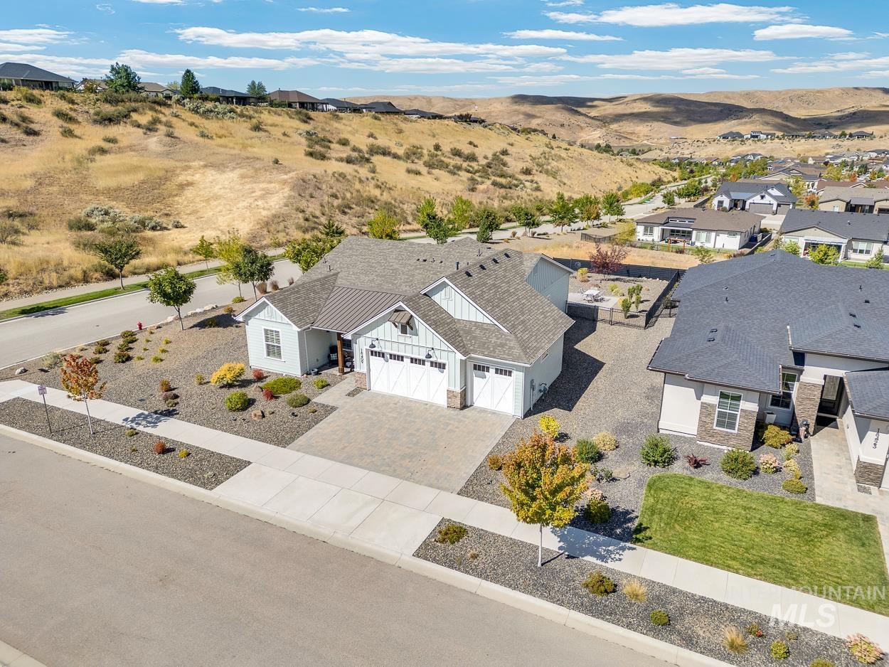 Aerial view of property and surrounding area featuring mountains