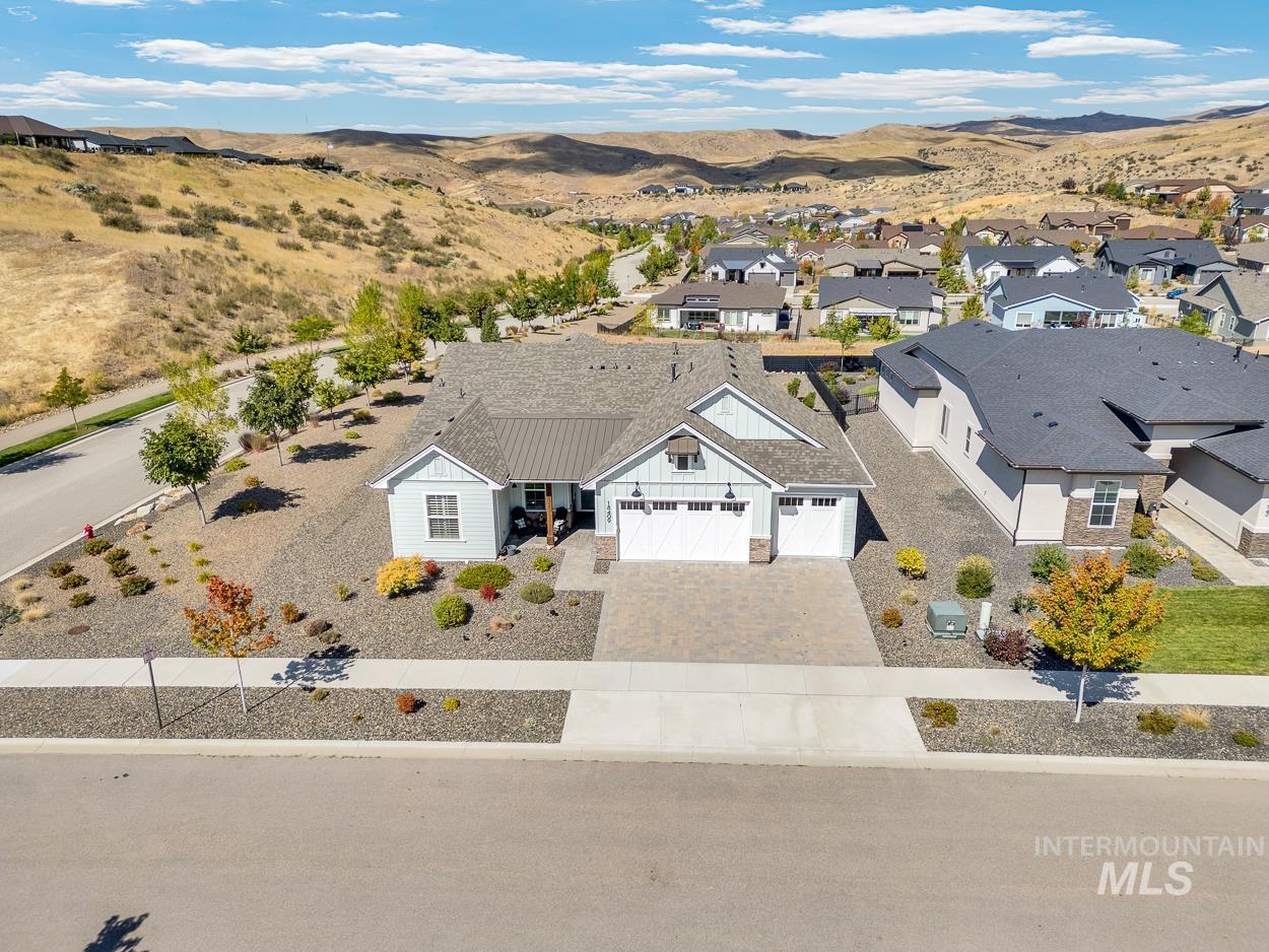 Aerial view of property and surrounding area featuring mountains