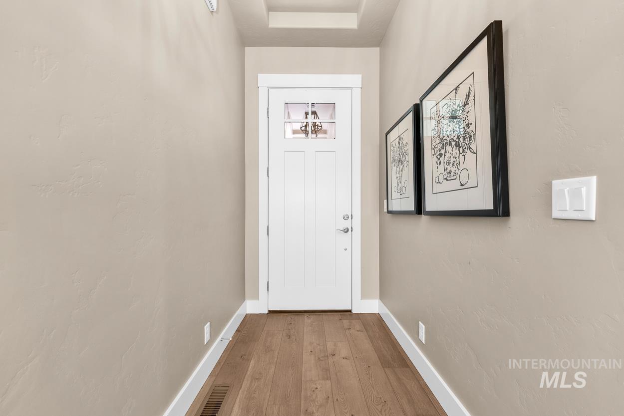 Entryway featuring wood-type flooring and baseboards