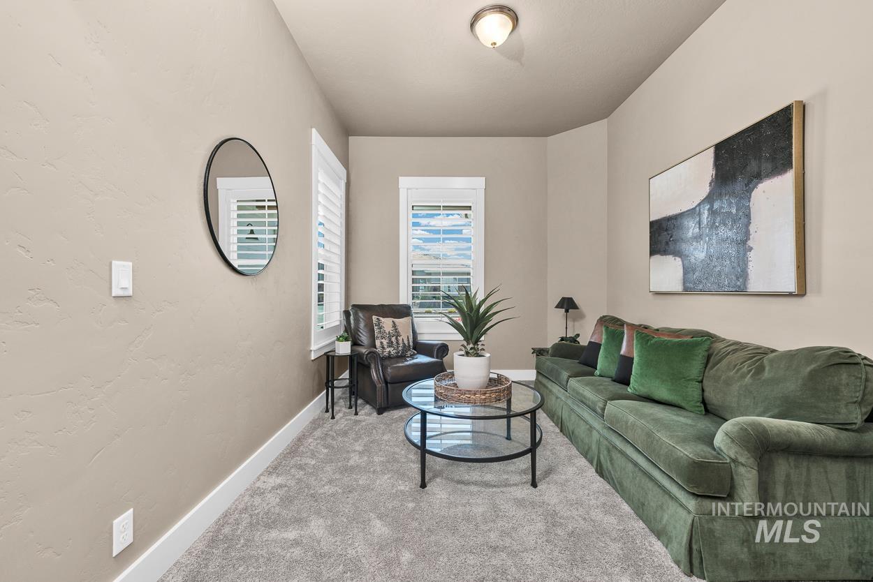 Living area with carpet and a textured wall