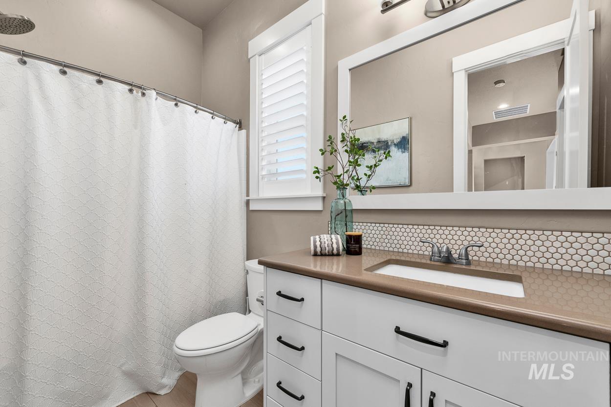 Full bathroom featuring vanity and a shower with shower curtain