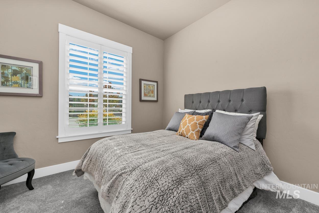 Carpeted bedroom featuring baseboards