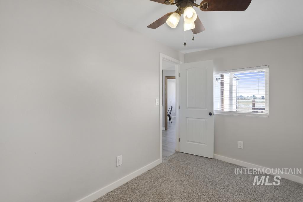 Unfurnished bedroom featuring carpet flooring and ceiling fan