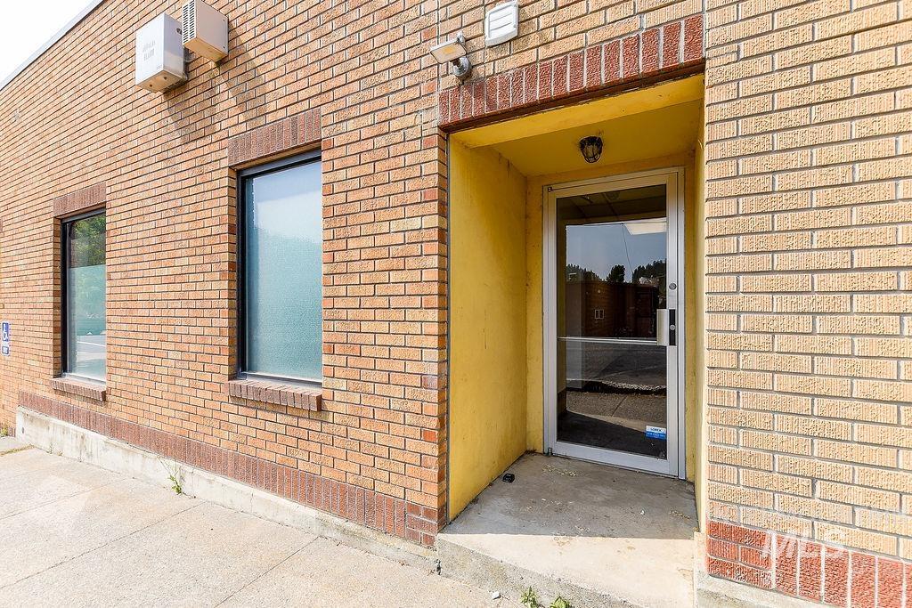 View of exterior entry with brick siding