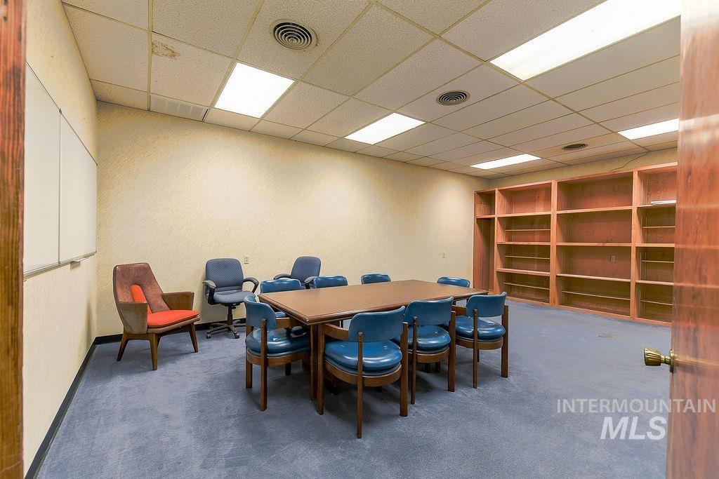 Dining room with a paneled ceiling and carpet