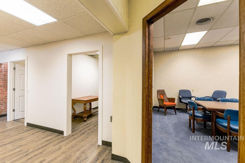 Office space featuring a paneled ceiling and wood finished floors