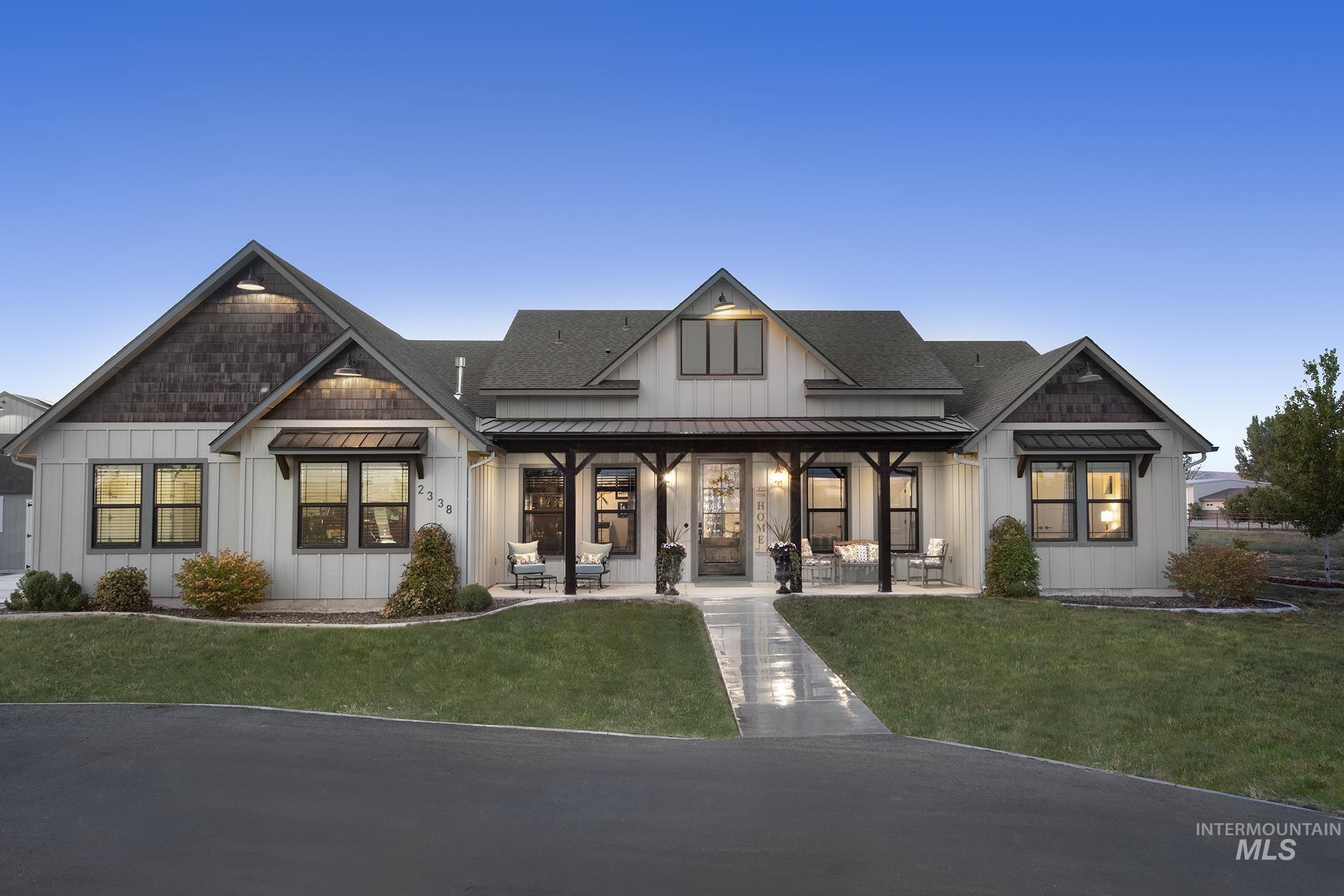 View of front of house featuring a standing seam roof, a metal roof, board and batten siding, a porch, and roof with shingles