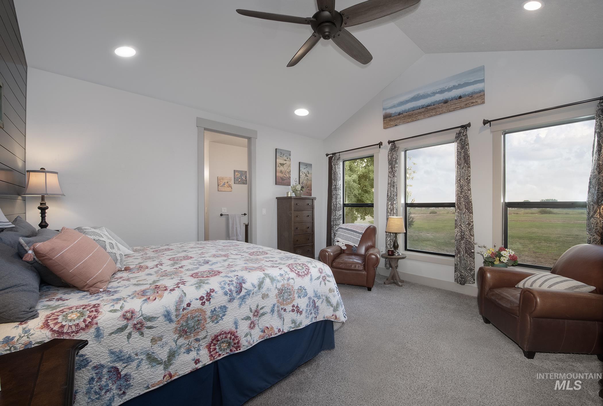 Carpeted bedroom with vaulted ceiling, recessed lighting, and a ceiling fan
