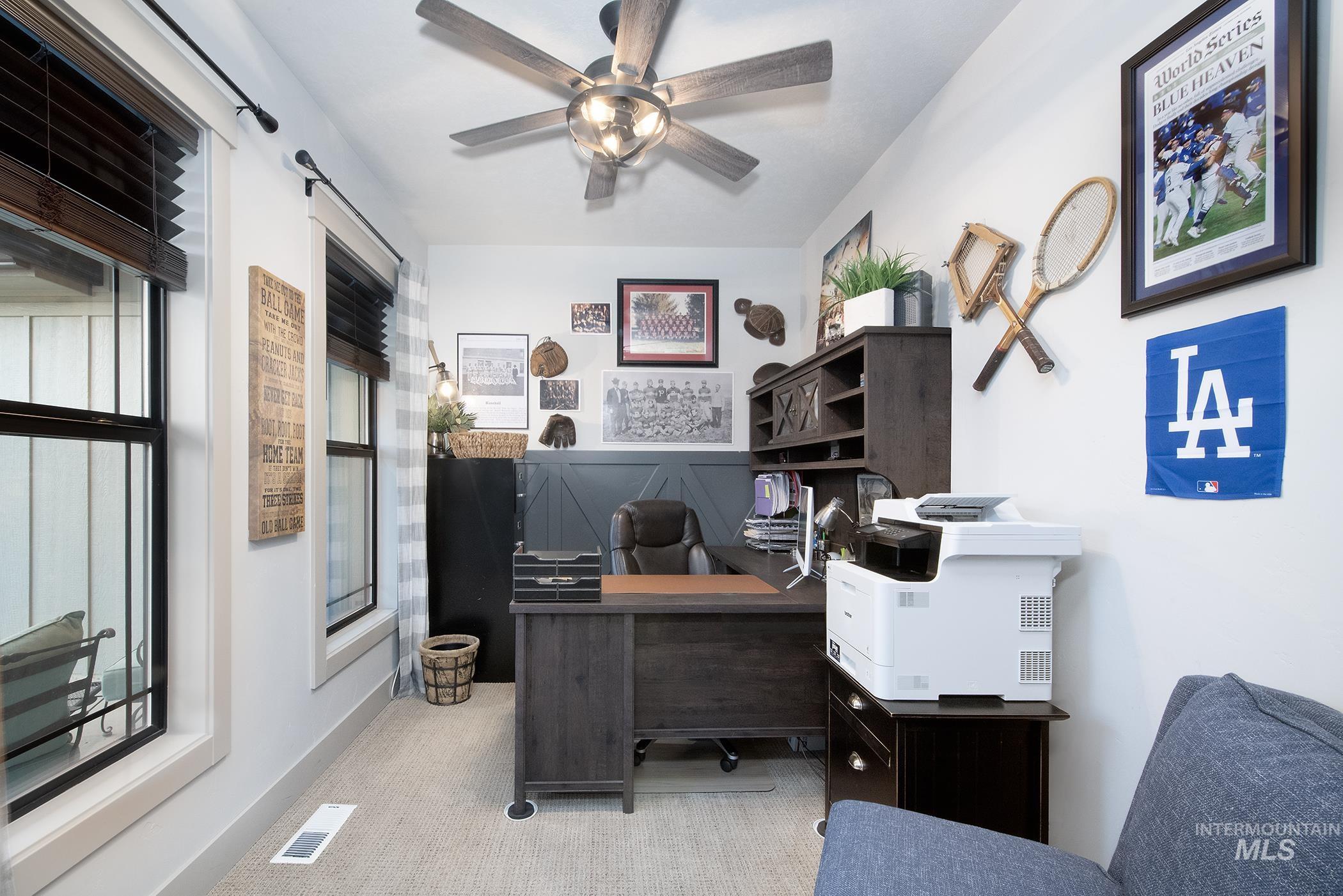 Home office with carpet floors and a ceiling fan