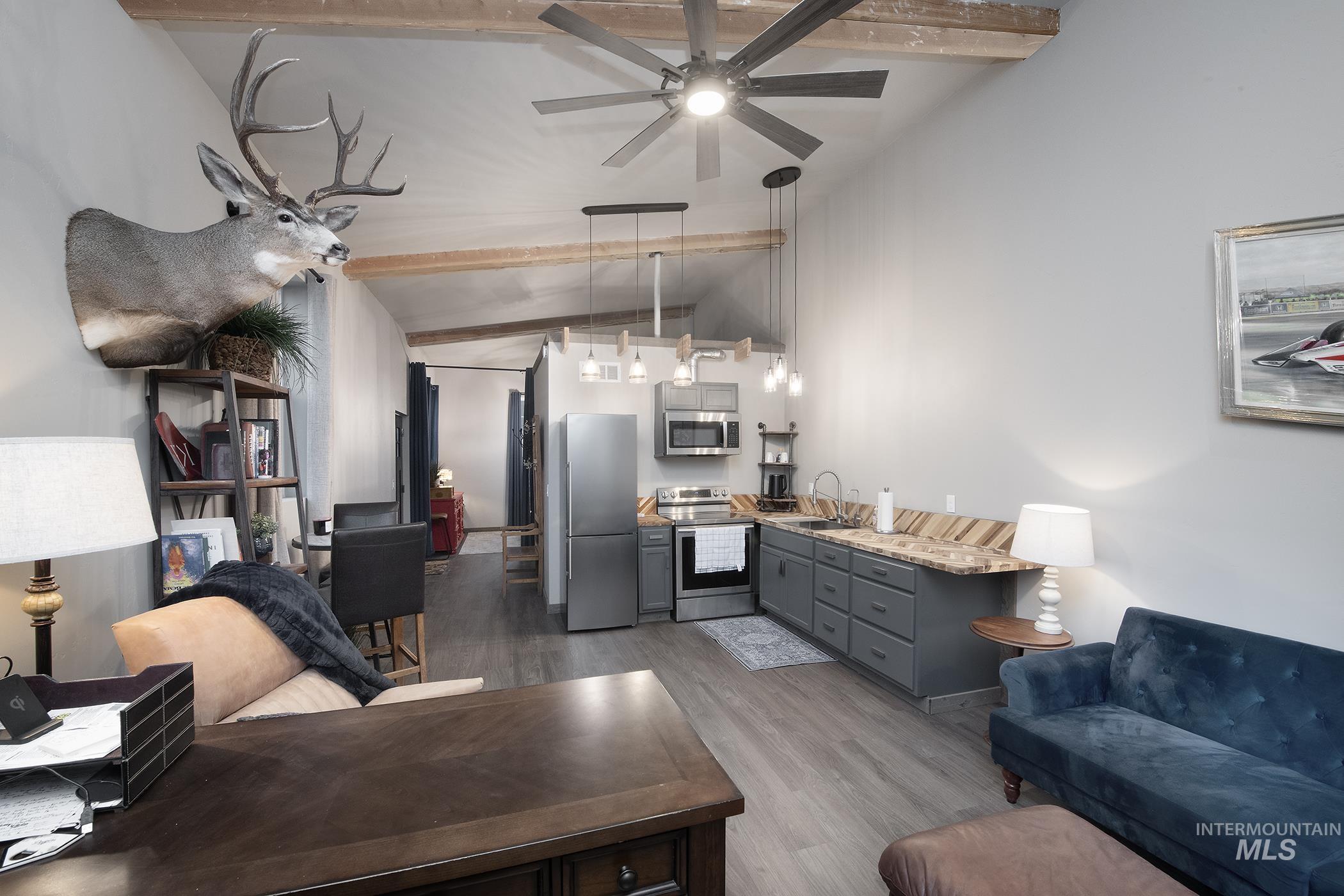 Living room with dark wood-type flooring and ceiling fan