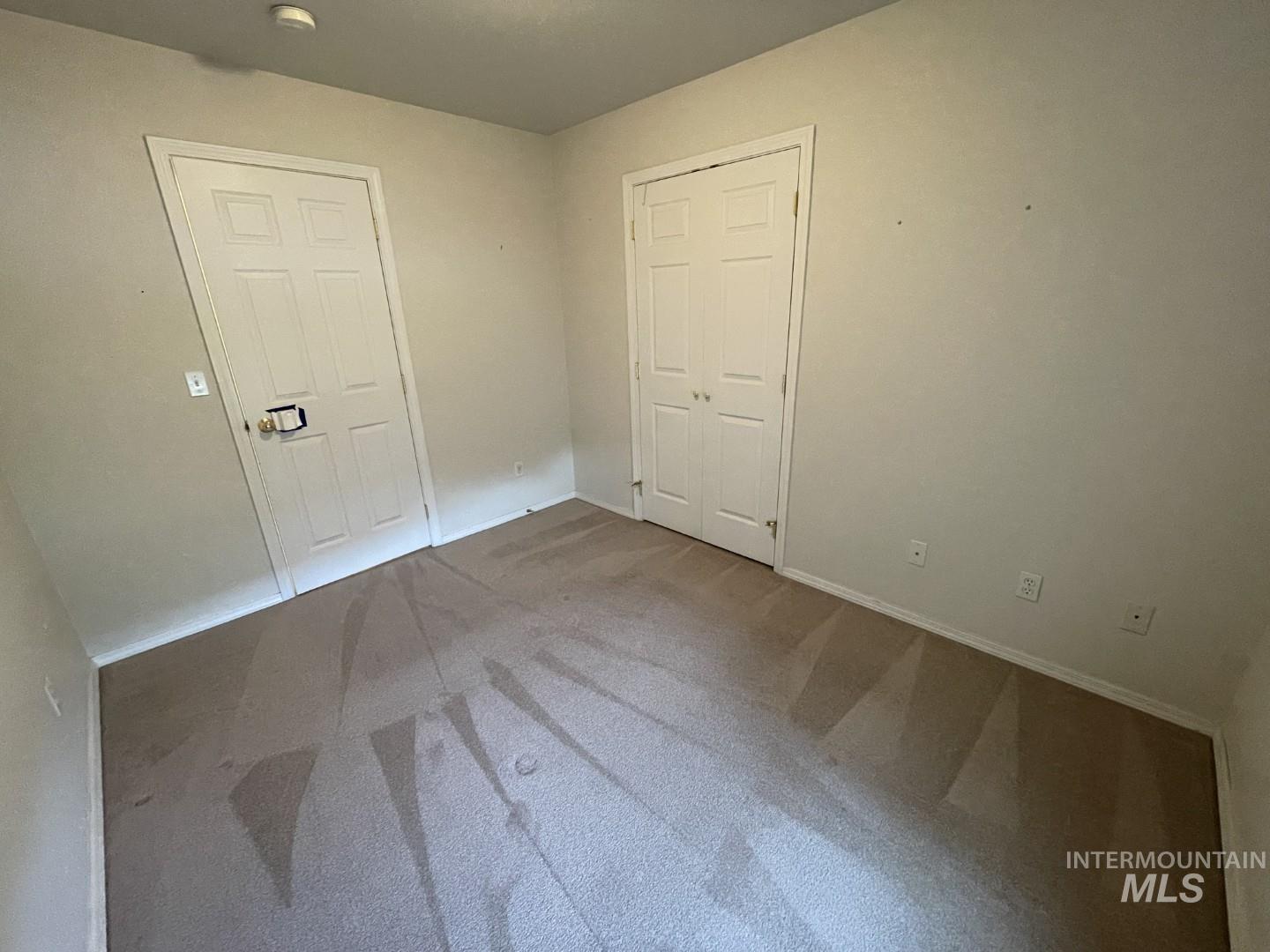 Unfurnished bedroom with carpet flooring and a closet