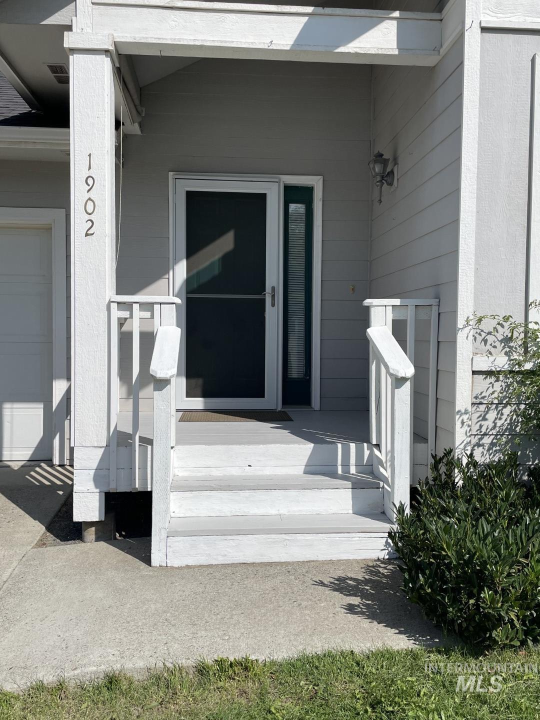 View of exterior entry with a garage