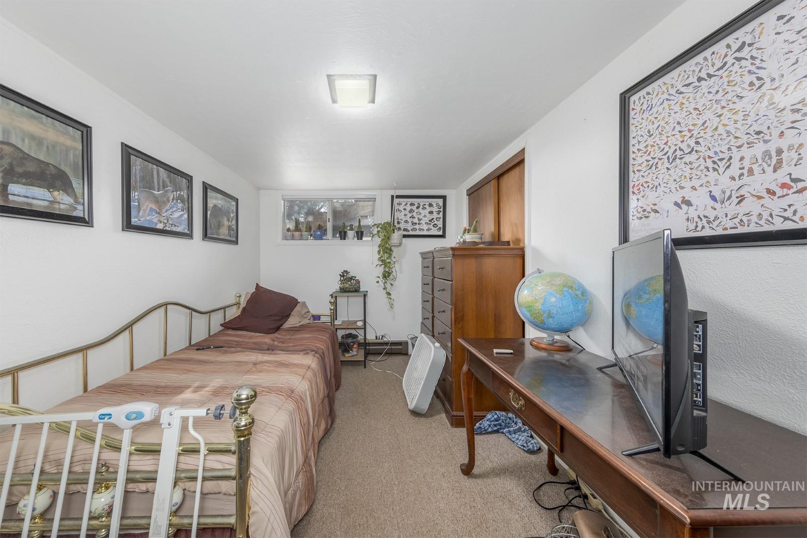 Bedroom featuring light colored carpet